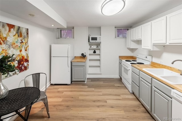 1120 N Clarkson St Unit 6, Denver, CO 80218 - kitchen with white appliances, a sink, gray cabinets, light wood-style floors, and baseboards