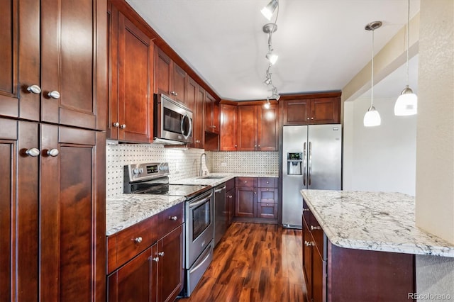 kitchen with pendant lighting, dark hardwood / wood-style floors, sink, appliances with stainless steel finishes, and light stone countertops