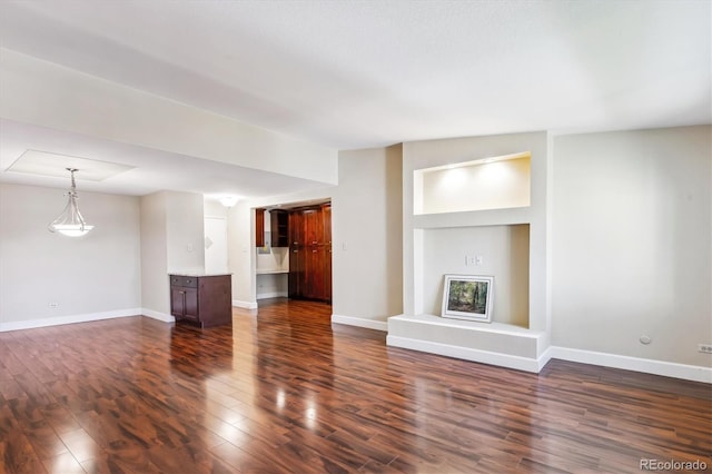 unfurnished living room featuring dark hardwood / wood-style floors