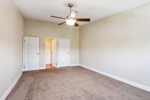 unfurnished bedroom featuring ceiling fan and carpet flooring