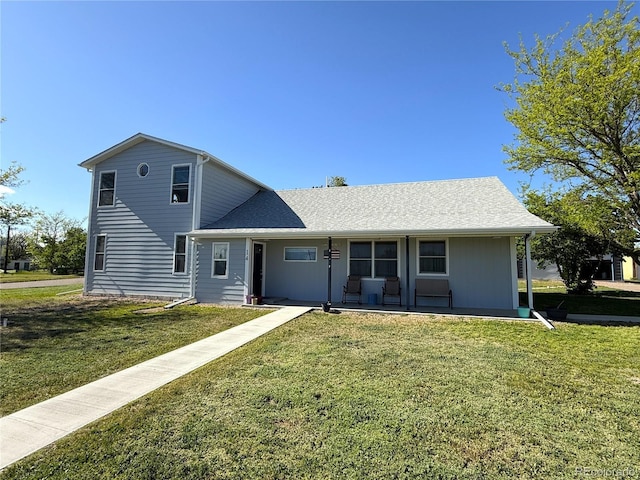 14 W 3rd St, Flagler, CO 80815 - traditional-style house featuring a porch, a front lawn, and a shingled roof
