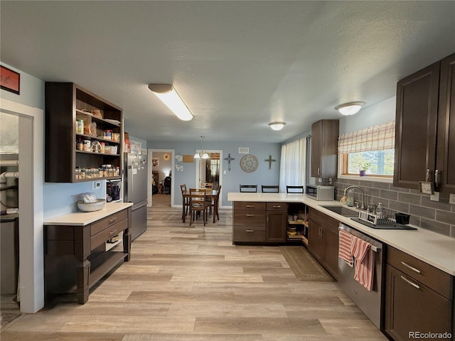 14 W 3rd St, Flagler, CO 80815 - kitchen with stainless steel appliances, a sink, light countertops, and light wood-style flooring