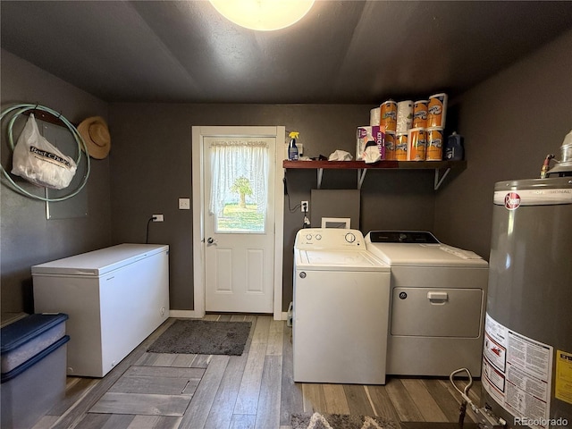 14 W 3rd St, Flagler, CO 80815 - laundry area with independent washer and dryer, gas water heater, wood-type flooring, and baseboards