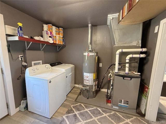 14 W 3rd St, Flagler, CO 80815 - laundry room featuring water heater, independent washer and dryer, and baseboards