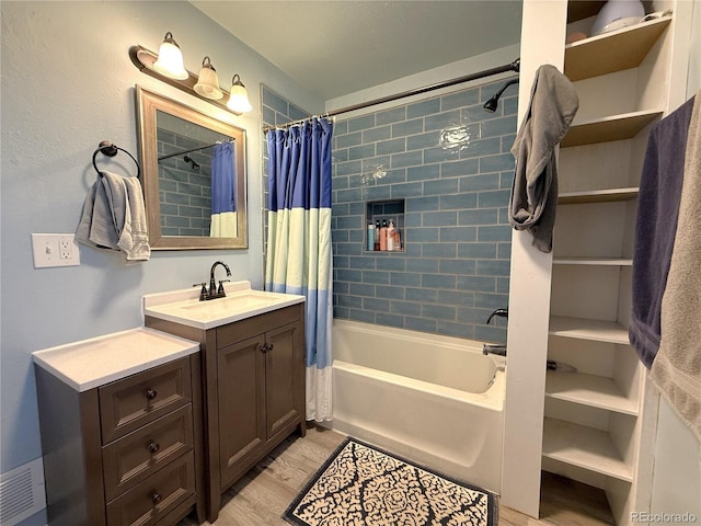 14 W 3rd St, Flagler, CO 80815 - bathroom featuring wood finished floors, shower / tub combo with curtain, and vanity