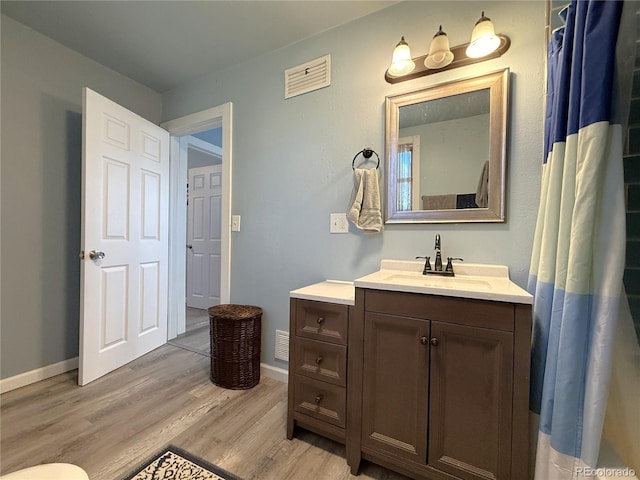 14 W 3rd St, Flagler, CO 80815 - bathroom with wood finished floors, vanity, and baseboards