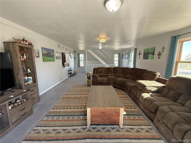 14 W 3rd St, Flagler, CO 80815 - carpeted living room with stairway, baseboards, and a textured ceiling