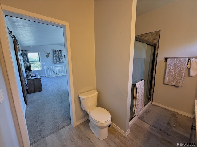 14 W 3rd St, Flagler, CO 80815 - bathroom featuring wood finished floors, toilet, a shower stall, and baseboards