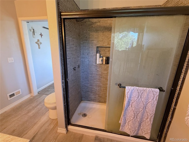 14 W 3rd St, Flagler, CO 80815 - full bath with wood finished floors, a shower stall, toilet, and baseboards