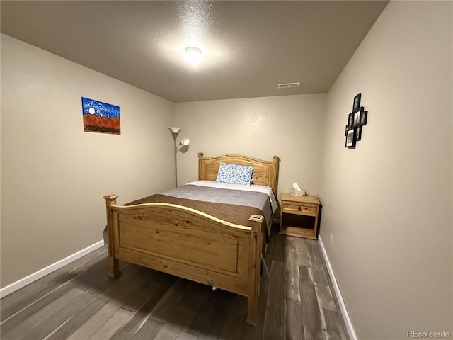 14 W 3rd St, Flagler, CO 80815 - bedroom featuring dark wood-style floors and baseboards