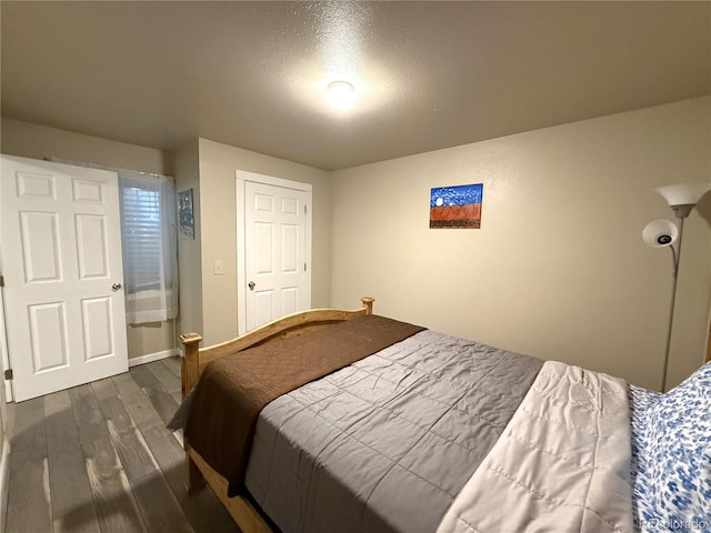 14 W 3rd St, Flagler, CO 80815 - bedroom featuring dark wood-style flooring, baseboards, and a textured ceiling