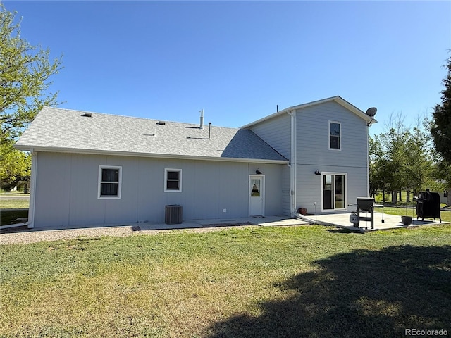 14 W 3rd St, Flagler, CO 80815 - rear view of property with a patio area, a lawn, central AC, and a shingled roof