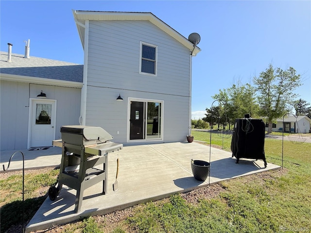 14 W 3rd St, Flagler, CO 80815 - back of house with a patio area, a yard, and roof with shingles