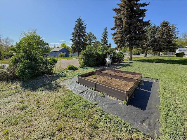14 W 3rd St, Flagler, CO 80815 - view of property's community featuring a vegetable garden and a lawn