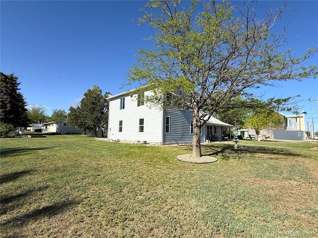14 W 3rd St, Flagler, CO 80815 - view of side of home featuring a lawn