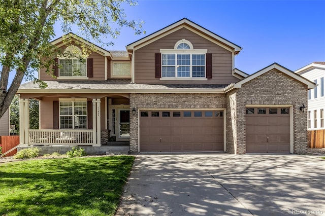 traditional-style home with an attached garage, a front lawn, a porch, driveway, and brick siding