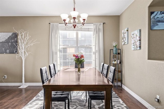 dining area featuring plenty of natural light, dark wood-type flooring, and a notable chandelier