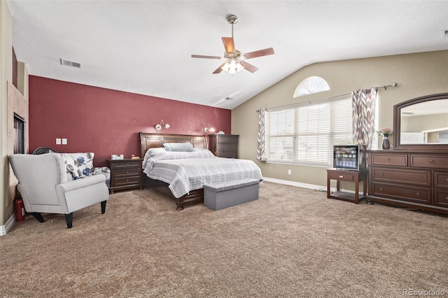 bedroom featuring lofted ceiling, carpet flooring, baseboards, and visible vents