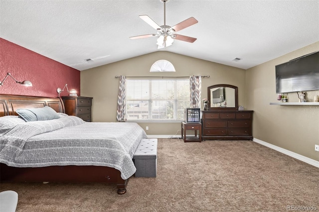 carpeted bedroom with baseboards, ceiling fan, visible vents, and vaulted ceiling