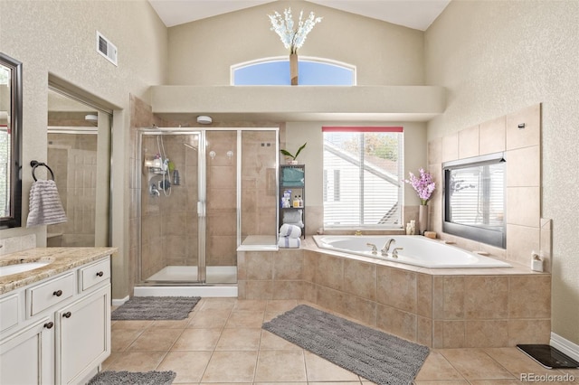 bathroom with vanity, shower with separate bathtub, tile patterned flooring, and high vaulted ceiling