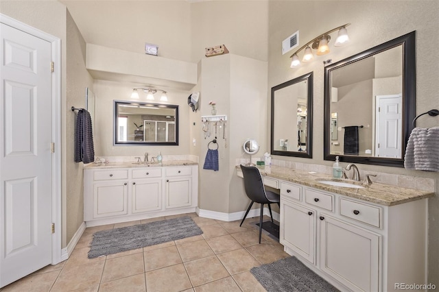 full bathroom with a sink, tile patterned flooring, baseboards, and visible vents