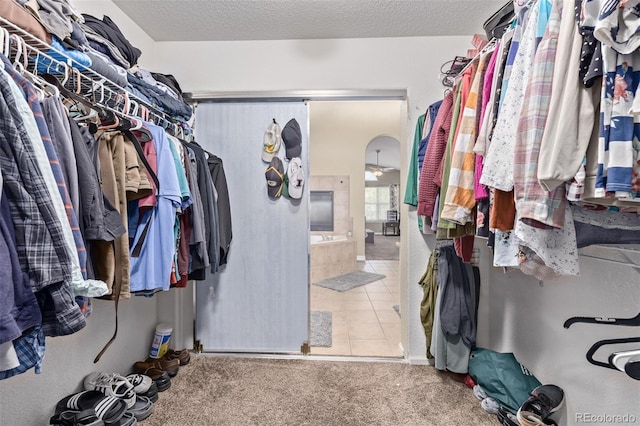 spacious closet featuring tile patterned flooring and carpet