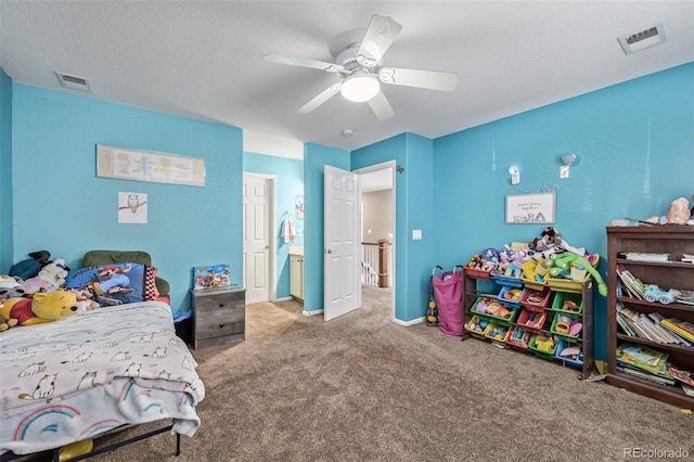 carpeted bedroom with a textured ceiling and ceiling fan