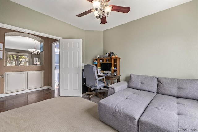 office space featuring ceiling fan with notable chandelier and hardwood / wood-style floors