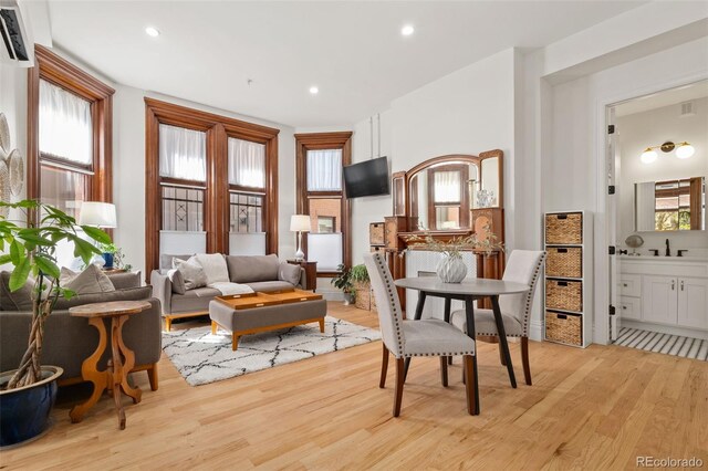 sitting room featuring light wood-type flooring, a wealth of natural light, and recessed lighting
