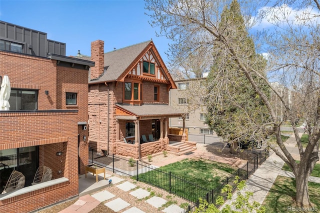 rear view of house featuring fence, a patio area, a chimney, and brick siding