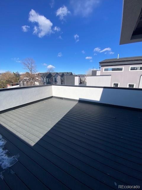 wooden terrace with a residential view