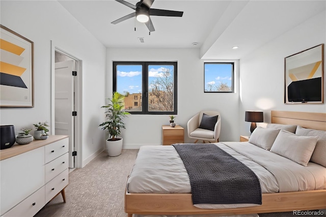 bedroom with light carpet, baseboards, and a ceiling fan