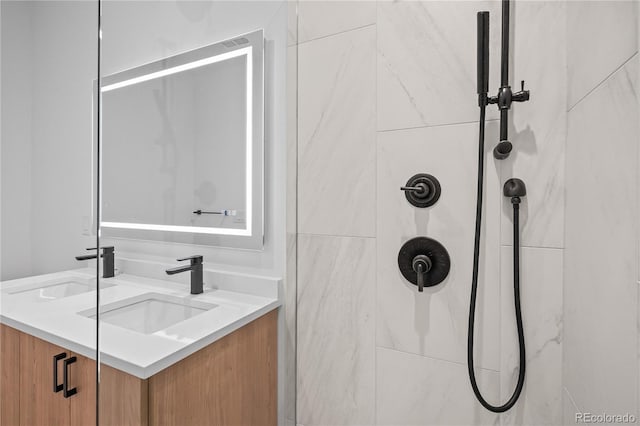 full bathroom featuring a shower and vanity