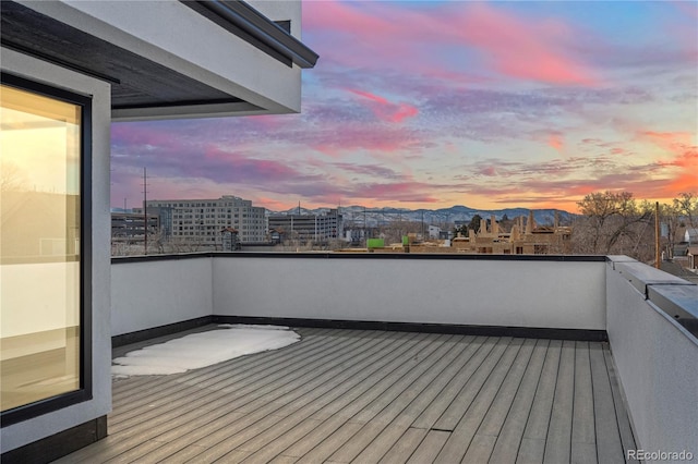 deck at dusk featuring a mountain view