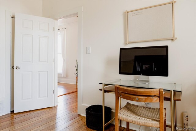 office featuring baseboards and hardwood / wood-style flooring