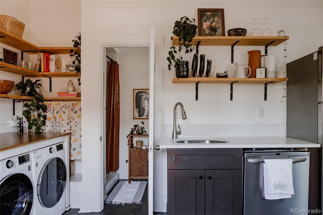 kitchen with open shelves, a sink, light countertops, separate washer and dryer, and stainless steel appliances
