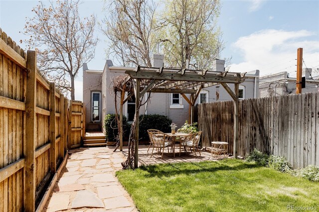 view of yard featuring a patio, a pergola, and a fenced backyard