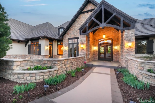 17540 Pond View Pl, Colorado Springs, CO 80908 - entrance to property featuring french doors, stone siding, a high end roof, and stucco siding