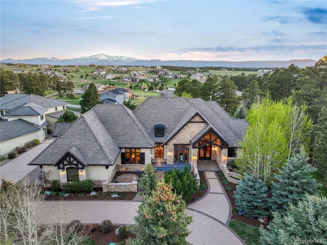 17540 Pond View Pl, Colorado Springs, CO 80908 - view of front of home featuring stone siding, stucco siding, and a mountain view