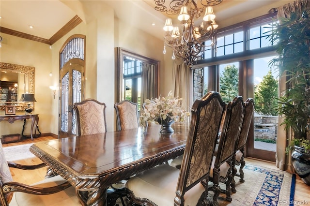 17540 Pond View Pl, Colorado Springs, CO 80908 - dining area featuring plenty of natural light, a chandelier, ornamental molding, wood finished floors, and baseboards