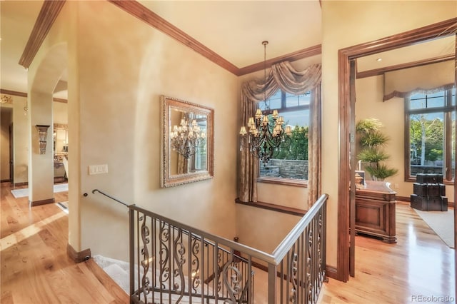 17540 Pond View Pl, Colorado Springs, CO 80908 - corridor with ornamental molding, an upstairs landing, wood finished floors, arched walkways, and a chandelier