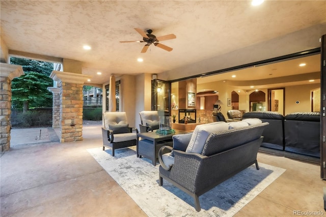 17540 Pond View Pl, Colorado Springs, CO 80908 - living area with ornate columns, ceiling fan, recessed lighting, and concrete floors