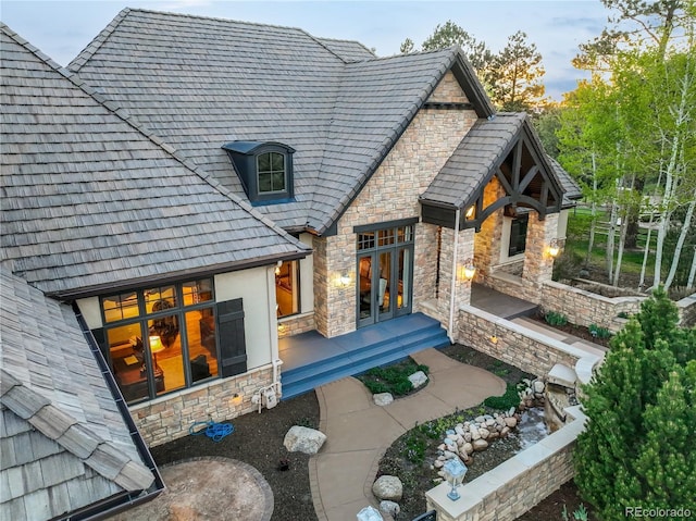 17540 Pond View Pl, Colorado Springs, CO 80908 - rear view of house with stone siding and french doors