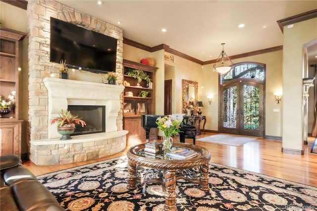 17540 Pond View Pl, Colorado Springs, CO 80908 - living room featuring wood finished floors, french doors, crown molding, built in features, and baseboards