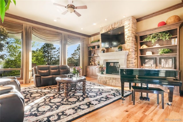 17540 Pond View Pl, Colorado Springs, CO 80908 - living room featuring ornamental molding, ceiling fan, wood finished floors, and a large fireplace