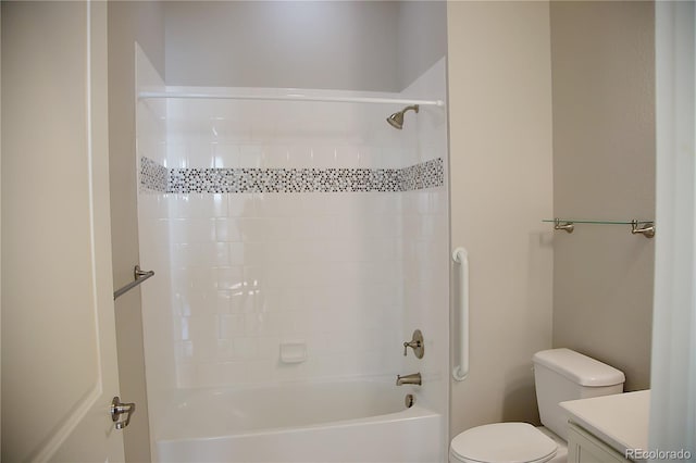 full bathroom featuring vanity, tiled shower / bath, and toilet