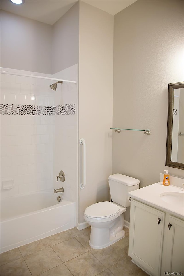 full bathroom featuring toilet, tiled shower / bath combo, vanity, and tile patterned flooring