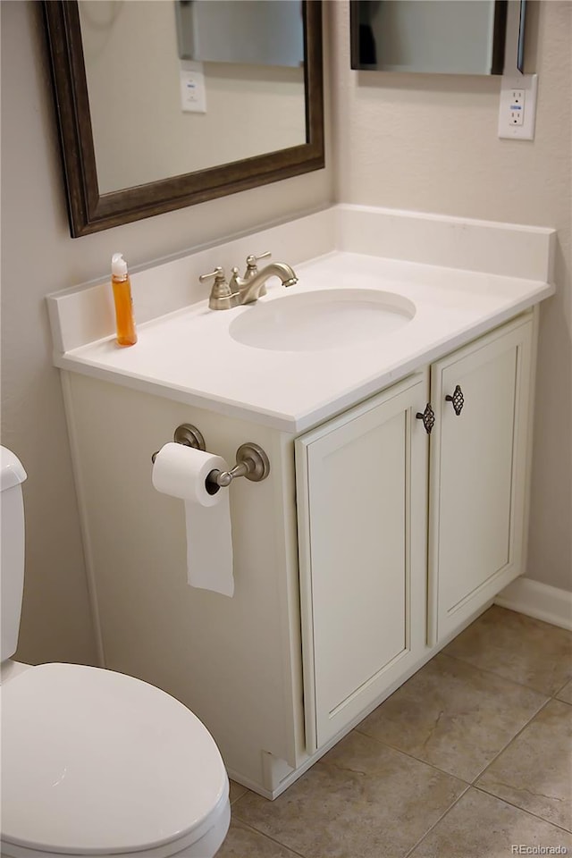 bathroom with vanity, toilet, and tile patterned flooring