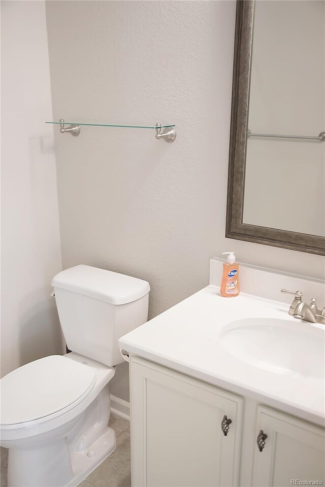 bathroom featuring vanity, toilet, and tile patterned floors