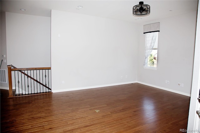 spare room with dark wood-type flooring